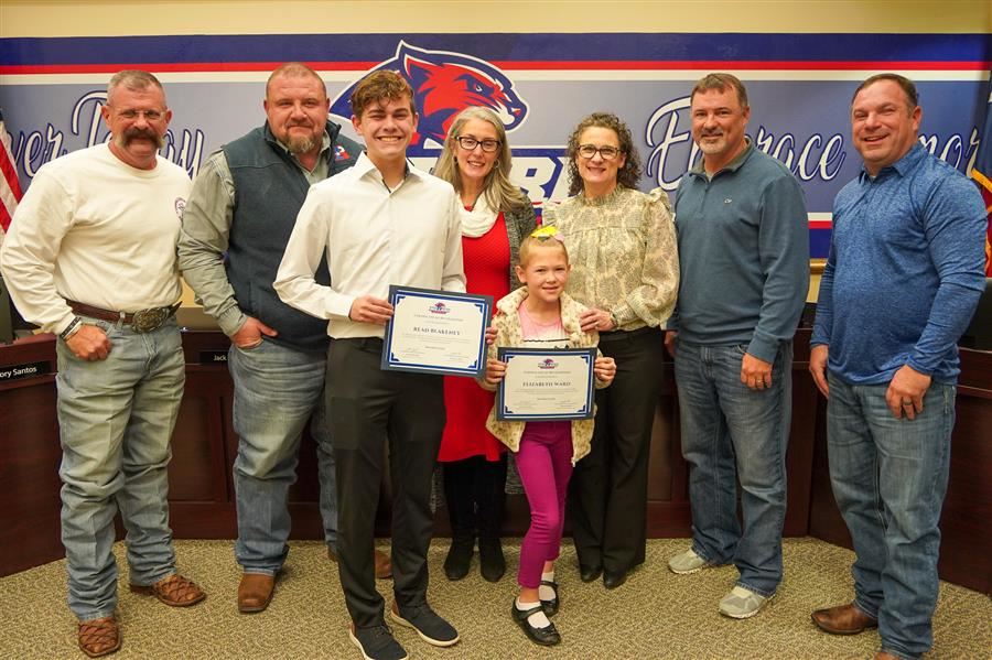  Students of the Month stand with Trustees